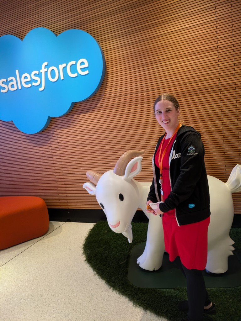 Kacie with Cloudy, the Salesforce mascot, at a Salesforce office